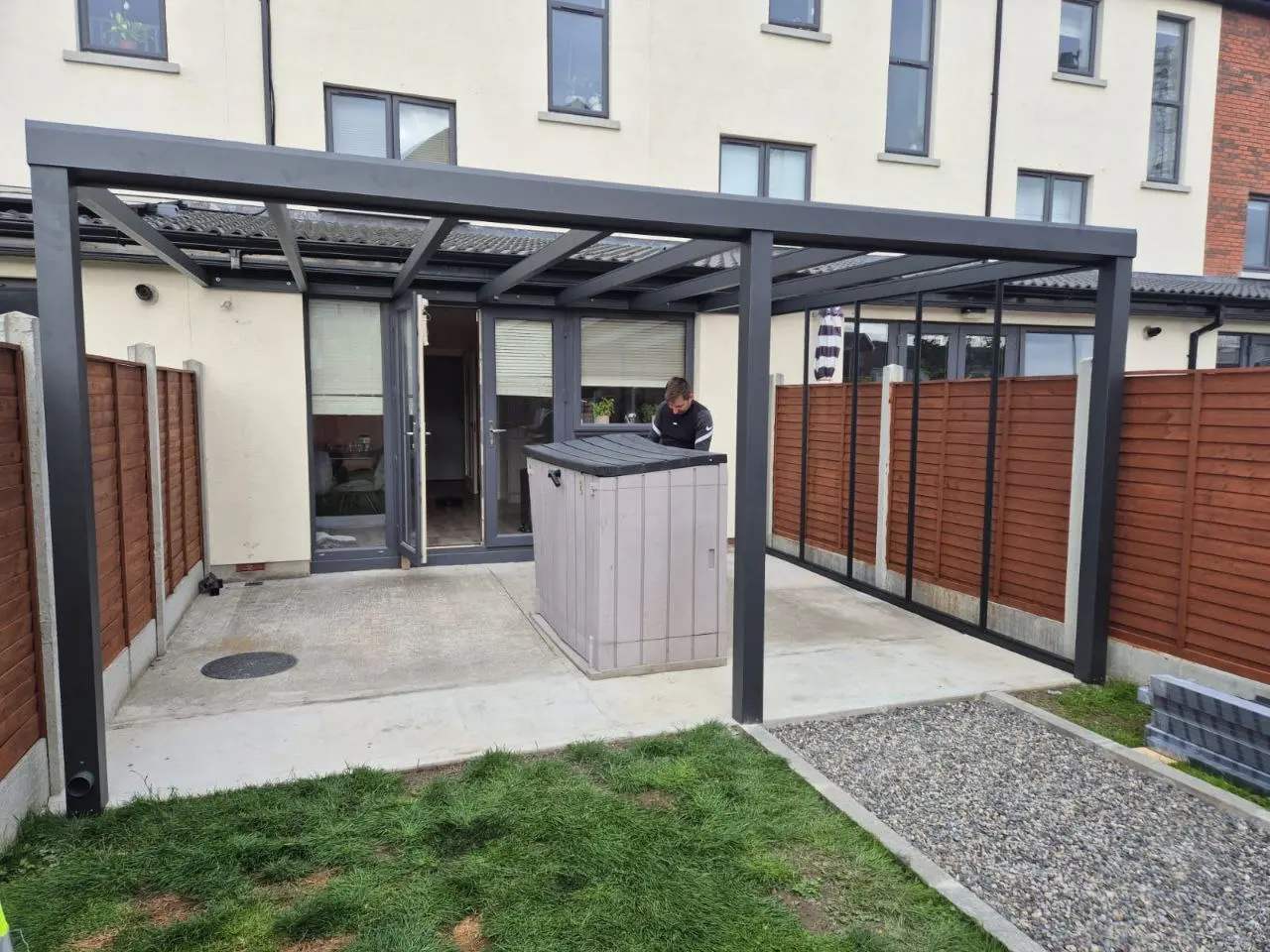 Aluminium pergola frame and right-side glass wall during installation in Dublin