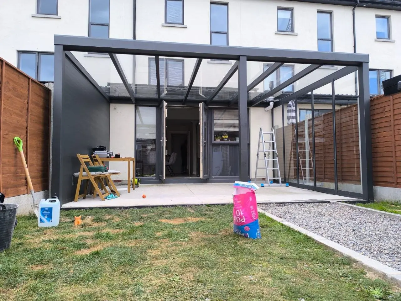 Glass roof and aluminium tongue-and-groove wall during installation in Dublin