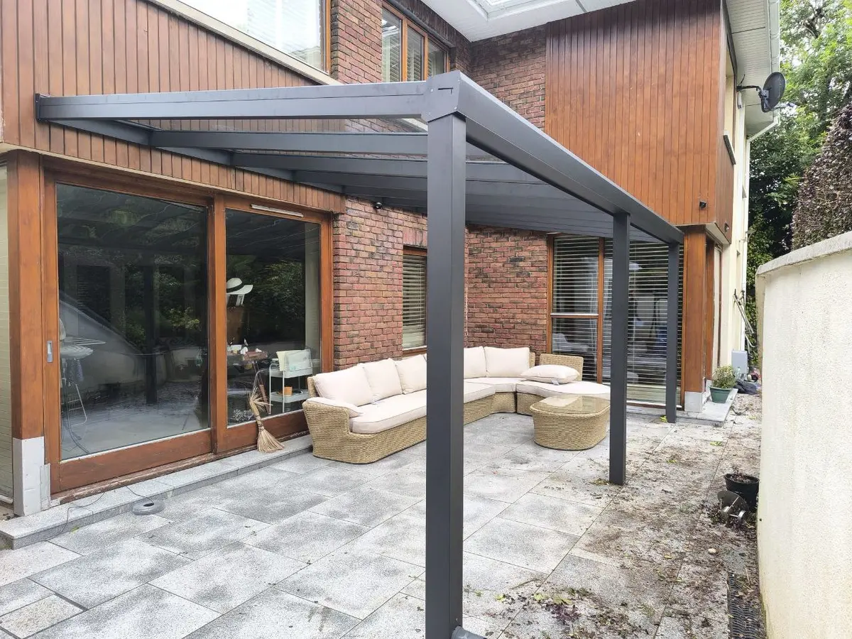 Completed black wall-mounted glass roof pergola at a residential property in Wexford
