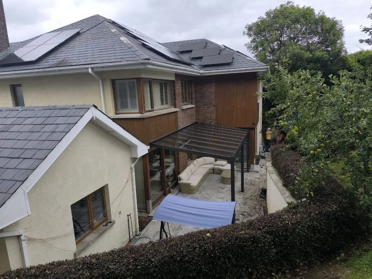 Elevated view of the wall-mounted glass pergola covering the rear patio in Wexford