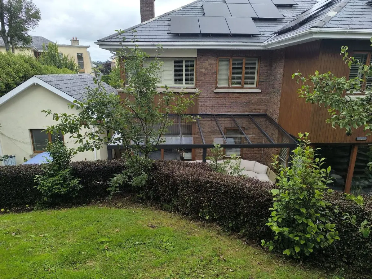 Garden view showing the glass roof pergola beside the Wexford home