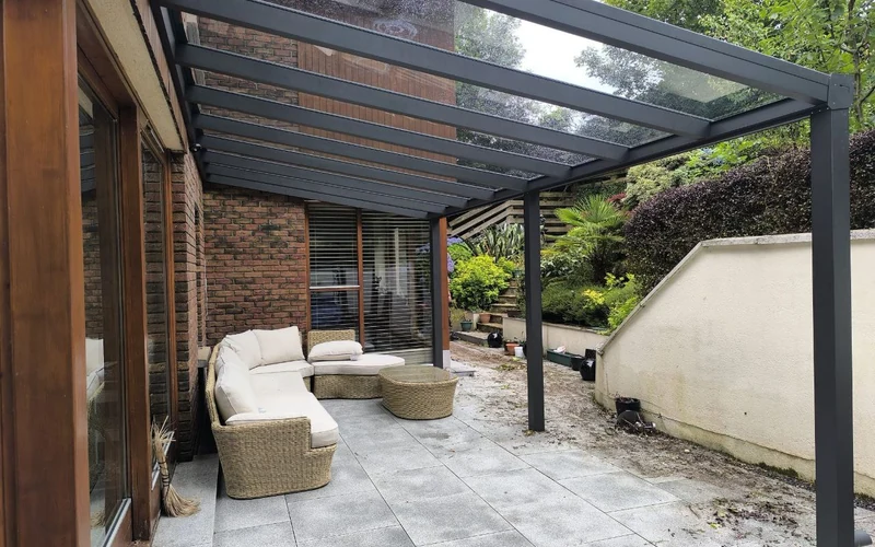 Wall-mounted aluminium pergola with a glass roof in County Wexford