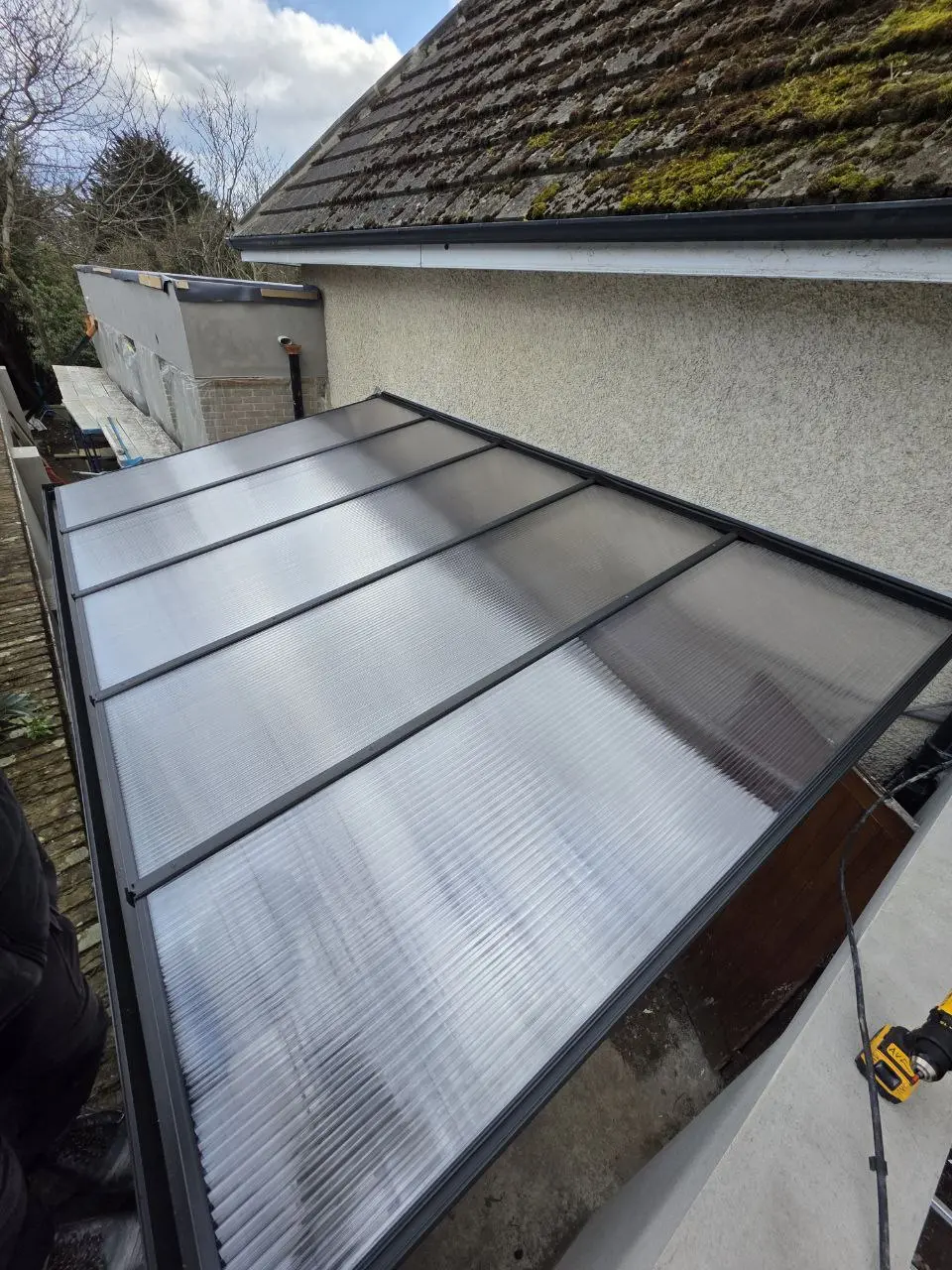 Clear polycarbonate roof on the completed wall-mounted canopy in Dublin