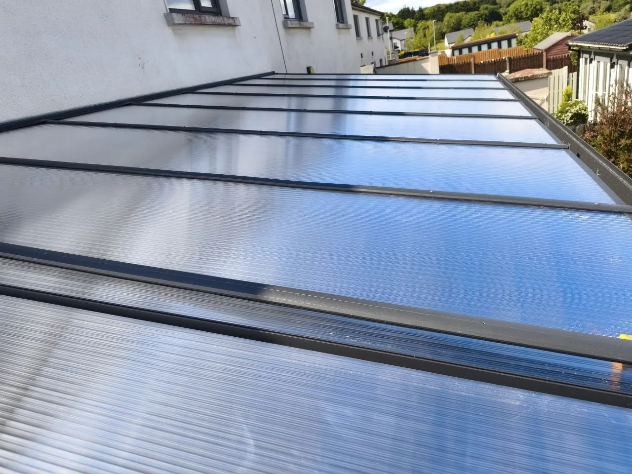 Transparent polycarbonate roof panels on the long aluminium pergola in Rathdrum