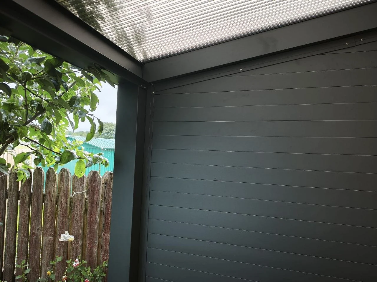 Interior view of the black aluminium privacy side wall beneath the pergola in Ennis