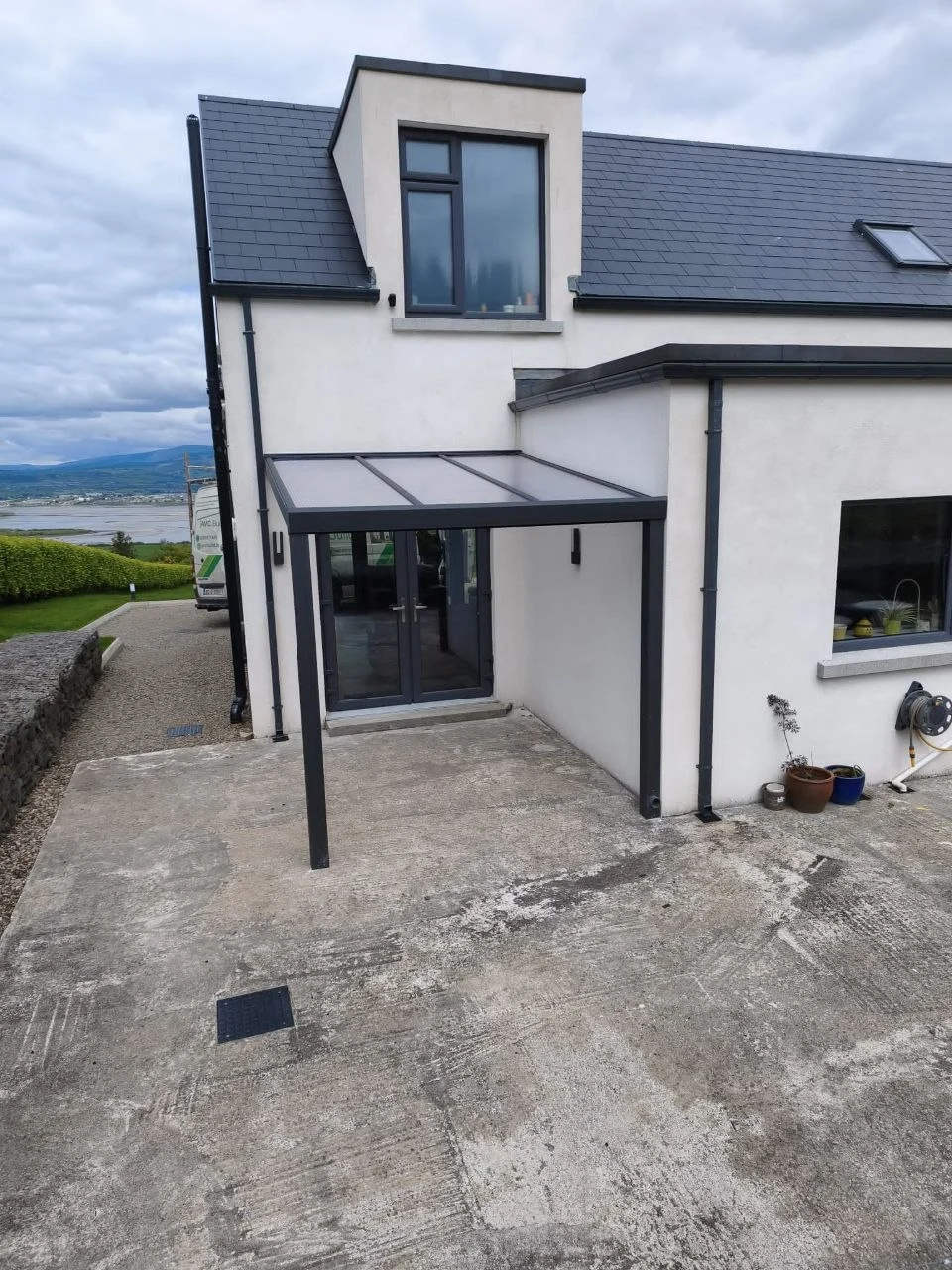 Completed anthracite wall-mounted polycarbonate entrance canopy in Leagh, Ring, County Waterford