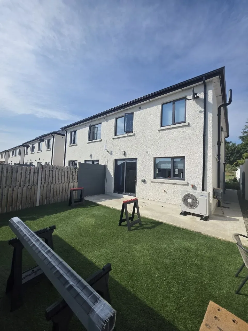 Aluminium profiles delivered beside the patio before pergola installation