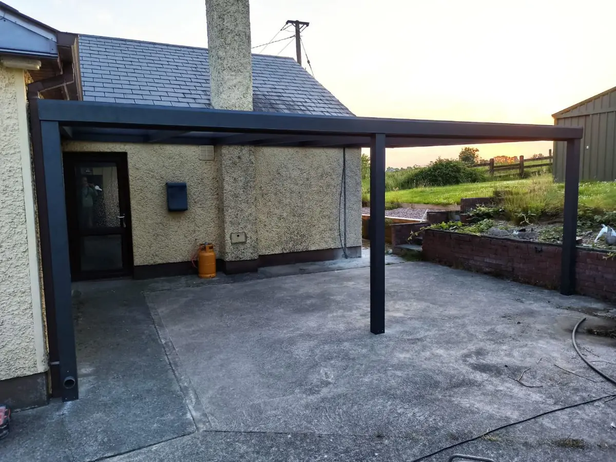 Front view of the black aluminium pergola covering the concrete terrace in County Monaghan