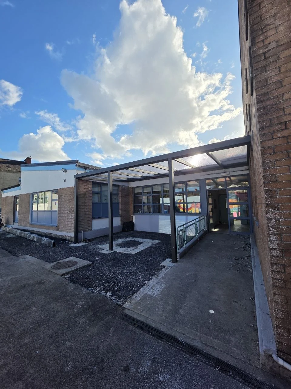 Wide view of the completed school entrance canopy and covered pedestrian area in Cashel