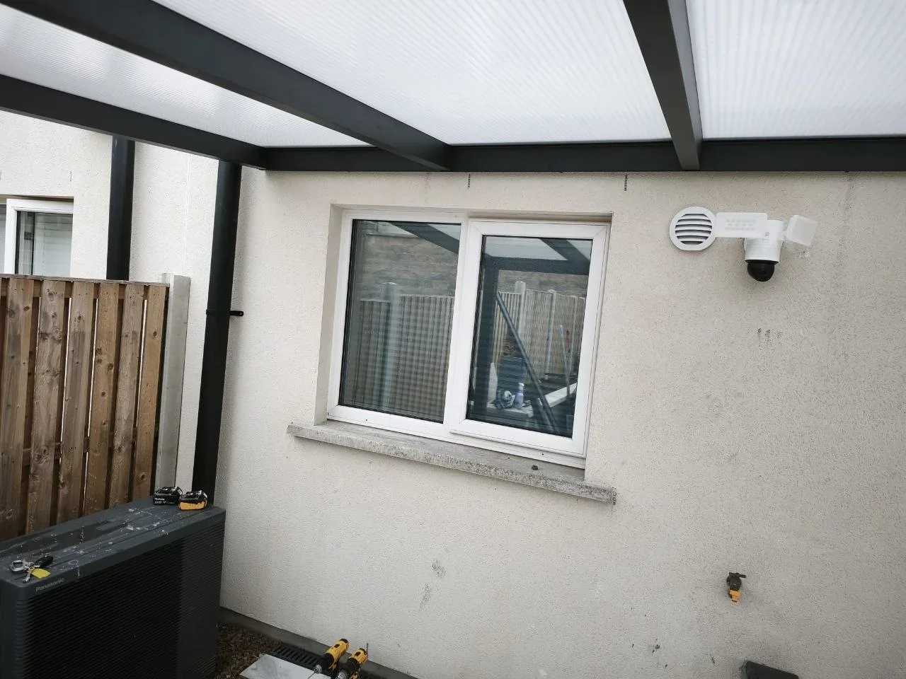 Under-roof detail of the completed polycarbonate pergola and sheltered patio in Cork